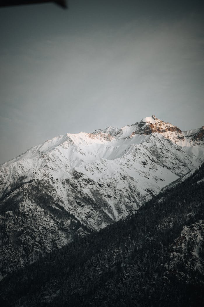 about-02 Stunning view of Himalayan mountains at sunrise, showcasing snow-capped beauty and rugged terrain.