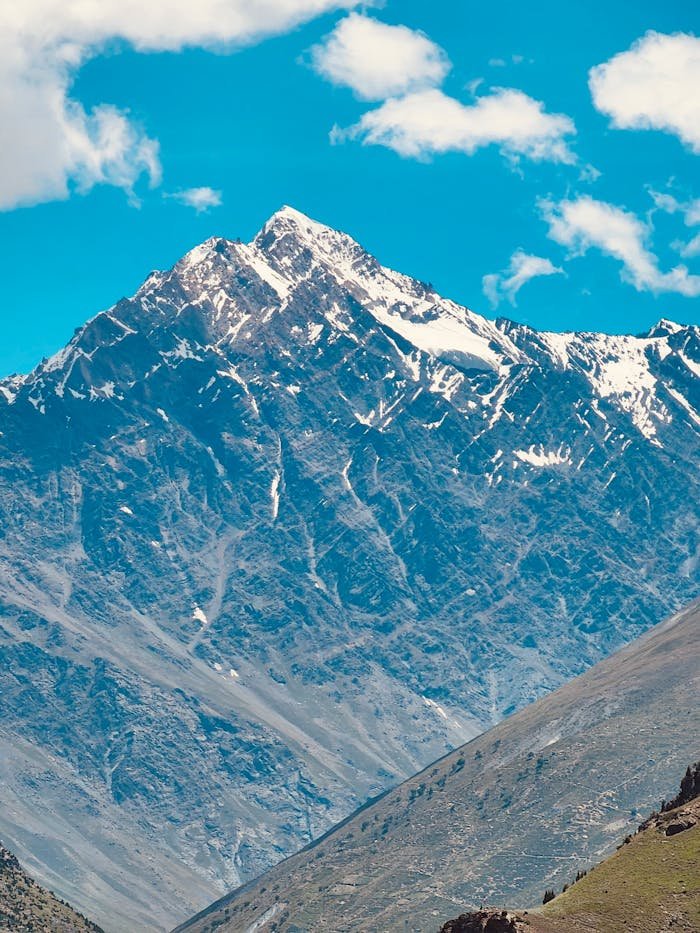 services-01 Breathtaking view of a snow-capped Himalayan peak under a clear blue sky.