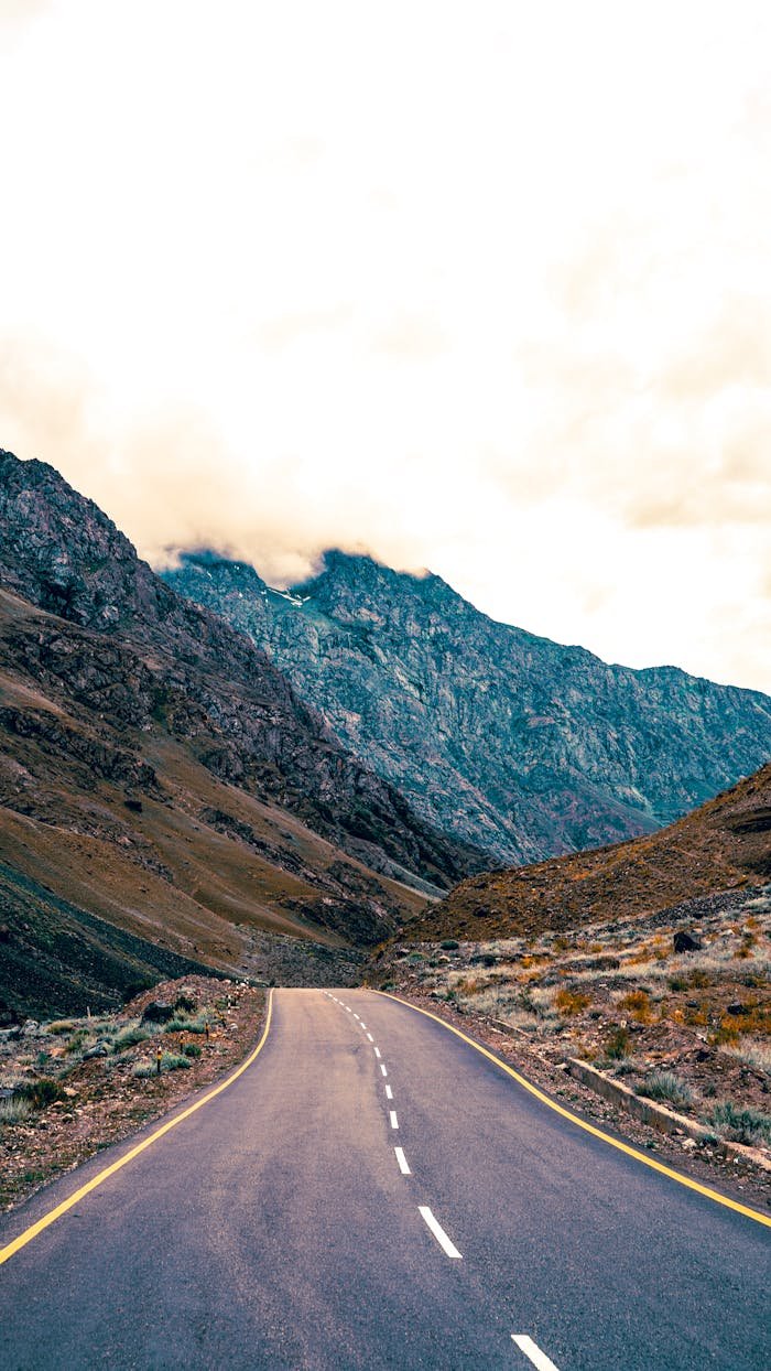 services-04 A scenic view of a deserted mountain road winding through the breathtaking landscapes of Kargil, Ladakh.
